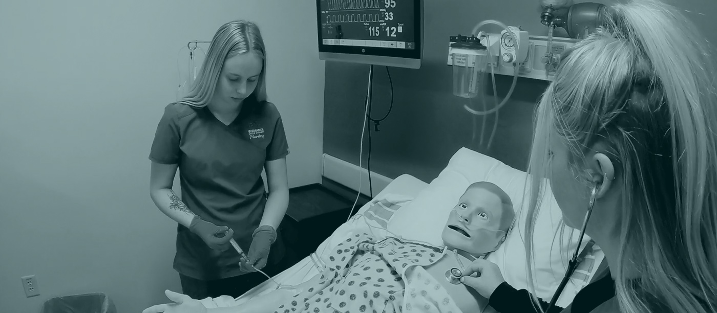 two nurses working on dummy patient