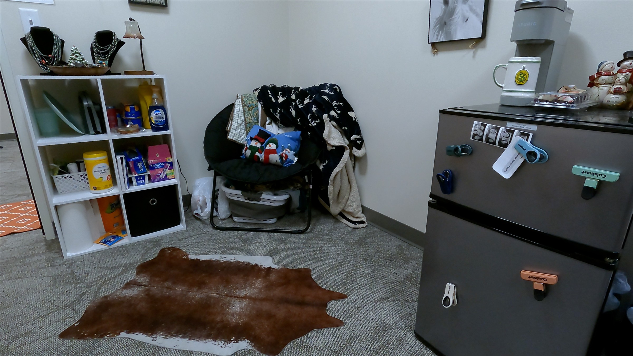 Interior of Health Science Hall dorm room with chair and mini fridge