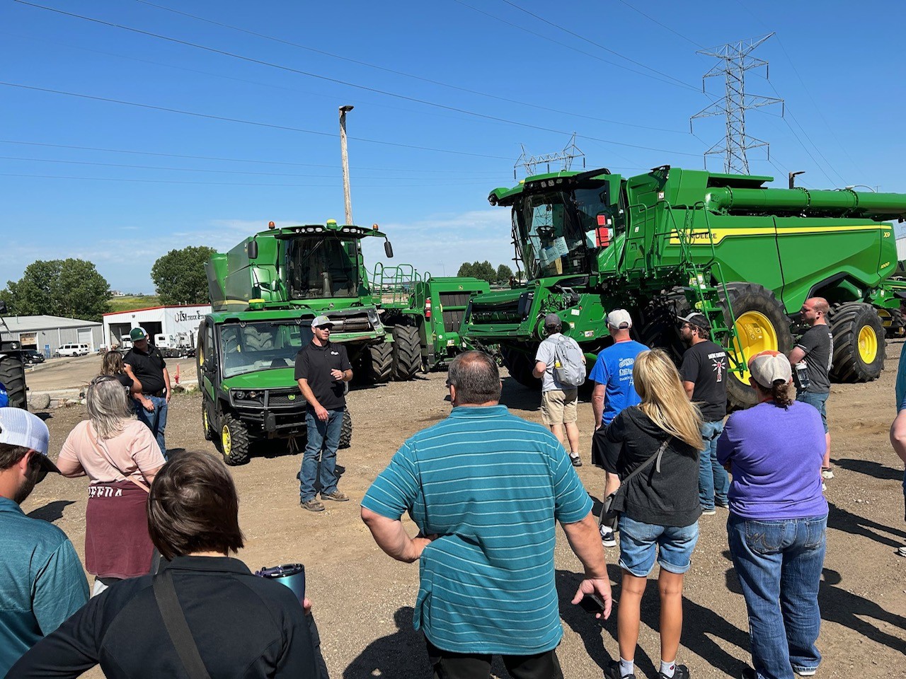 Community members standing by tractors in rural area