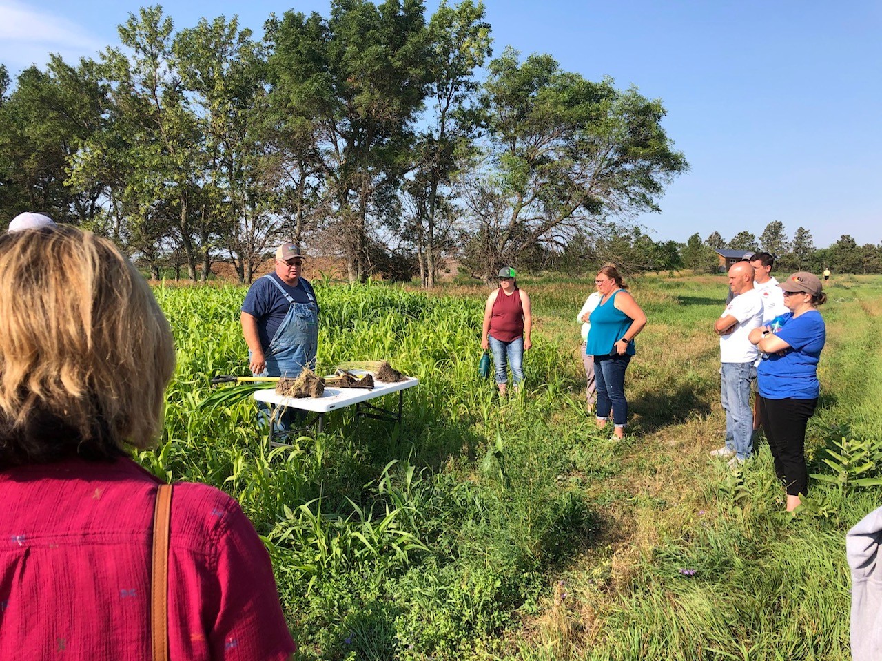 Group of people outside at farm learning about agriculture