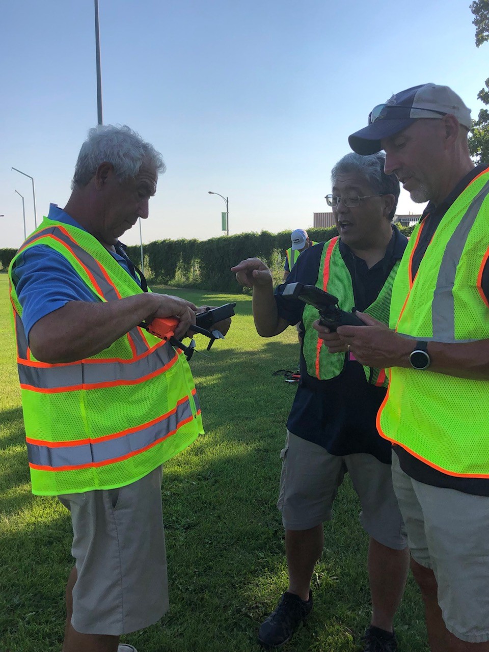 Workers looking at drone mechanisms 