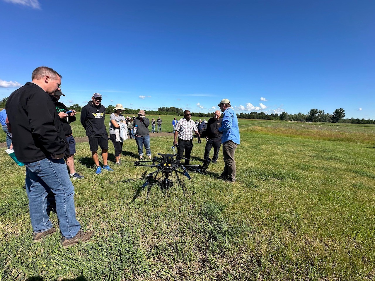 People working with a drone out in a field