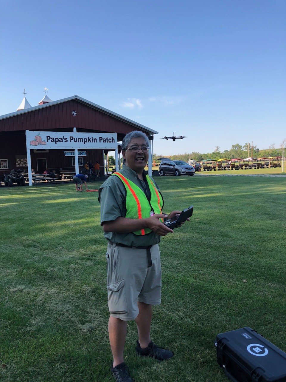 Man smiling while holding drone remote